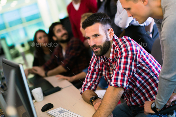 Programmer working in a software developing company - Stock Photo - Images
