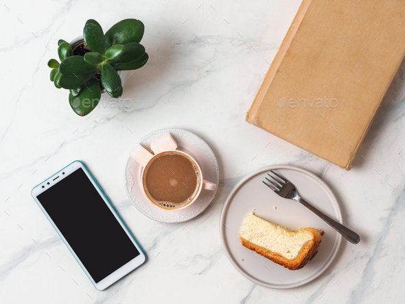 Coffee, cheescake, smartphone on tabletop
