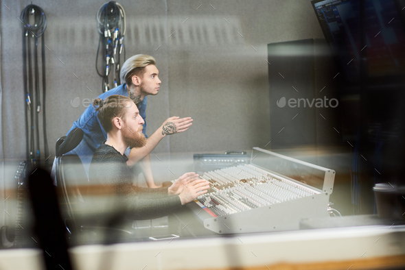 Creative producers making music in studio - Stock Photo - Images
