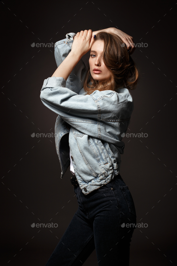 Sensual Female Model Posing in Denim Jacket, Jeans and White Socks on the  Floor near Beige Wall. Back to 1990s Fashion Lifestyle Style Concept Stock  Photo - Alamy