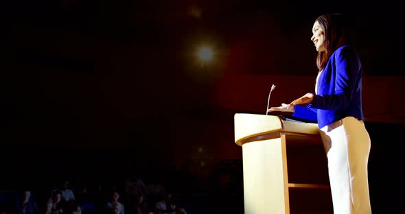 Young mixed-race businesswoman speaking in business seminar at auditorium 4k alt