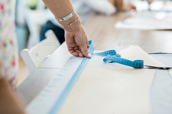 Female hands using wooden tailor ruler to measure cotton fabric. Textile  sale and sewing concept Stock Photo - Alamy