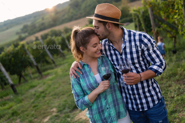 Woman and man in vineyard drinking wine - Stock Photo - Images