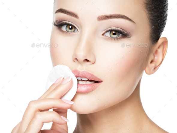 Beautiful woman cleans the face with  cotton swab. - Stock Photo - Images