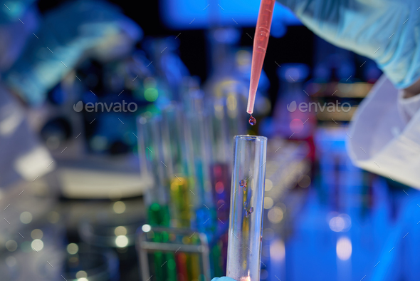 Scientist Pouring Liquid into Test Tube - Stock Photo - Images