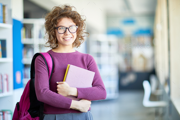 Dreamy student girl with books - Stock Photo - Images