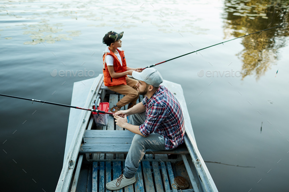 Enjoying fishing with dad Stock Photo by Pressmaster