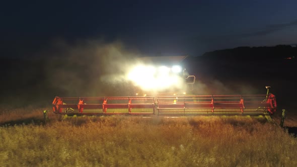 Combine Harvester at Night During the Harvest alt