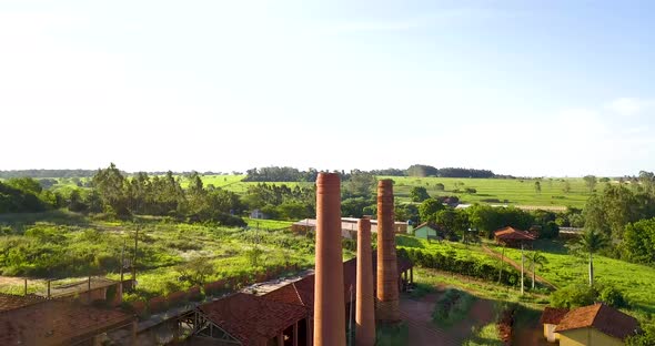 Chimneys of a industrial ceramic at sunny day. Aerial view tilt alt