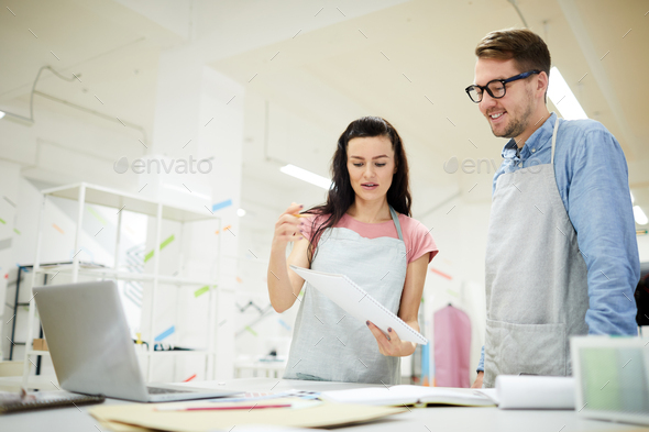 Lady explaining idea of fashion design to colleague Stock Photo by ...