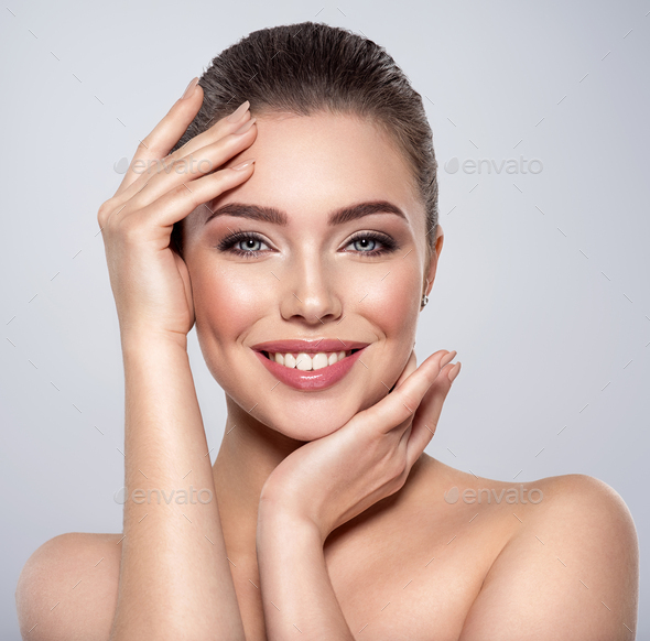 Beauty face of the young beautiful smiling woman - Stock Photo - Images