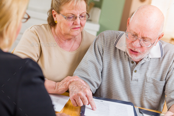 Senior Adult Couple Signing Papers