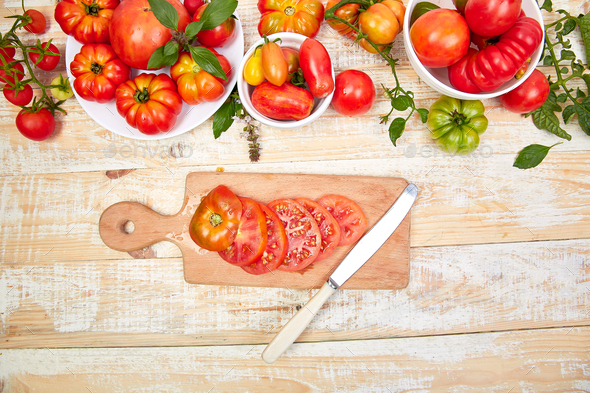 Chopped tomatoes and knife on cutting board. - Stock Photo - Images