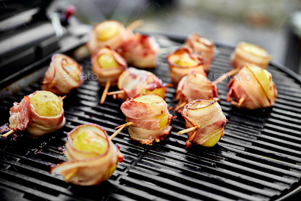 Grilled potato with bacon on gas grill . - Stock Photo - Images