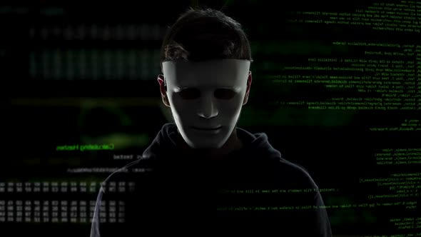 Scary Hacker in Mask Putting on His Black Hood, Cyber Terrorism and Hacking alt