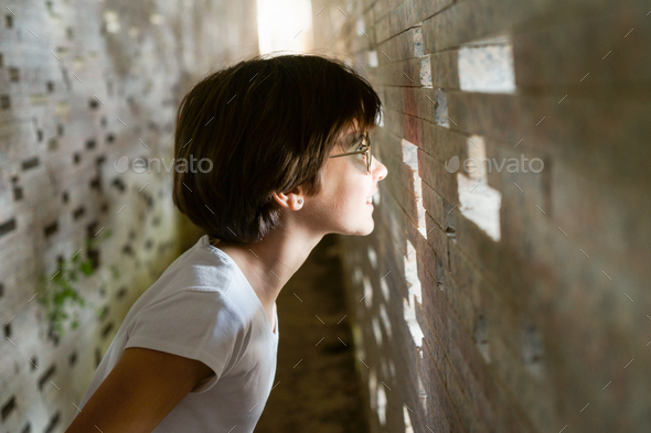 Child looking through the bricks inside the Nazari Wall - Stock Photo - Images