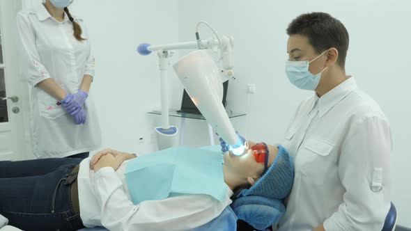 Dentist treating patient alt