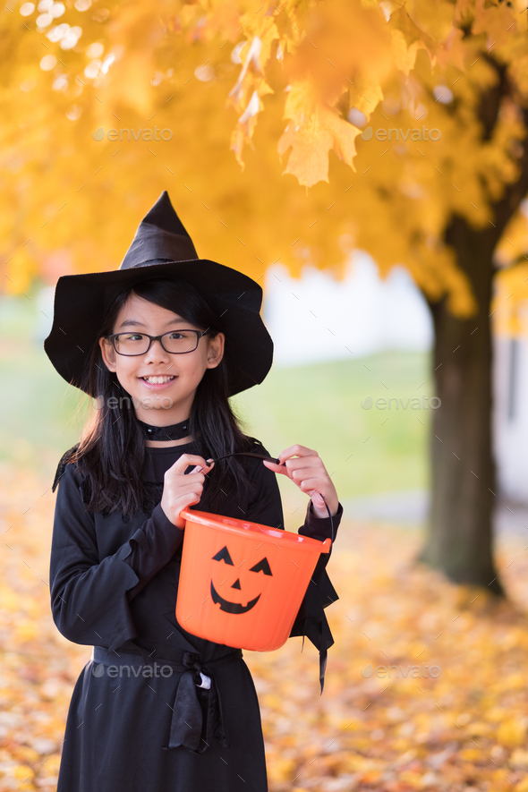 Portrait of little asian girl in witch costume Stock Photo by kenishirotie