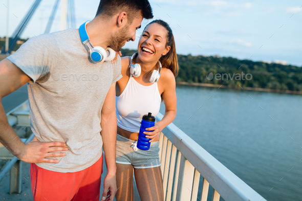 Portrait of man and woman during break of jogging - Stock Photo - Images