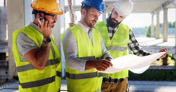 Architect consult engineer on modern construction site - Stock Photo - Images