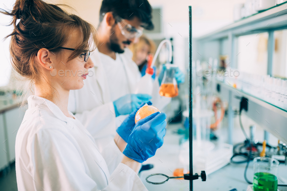 Young students of chemistry working in laboratory - Stock Photo - Images