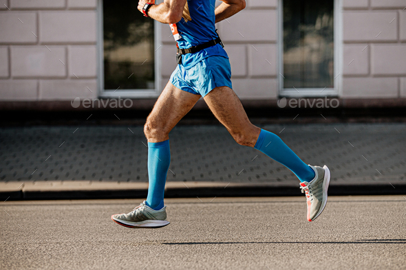 athlete runner in blue compression socks