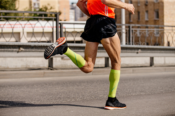 man runner in bright green compression socks