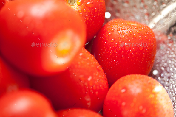 Macro of Fresh, Vibrant Roma Tomatoes in Colander with Water Drops Abstract. - Stock Photo - Images