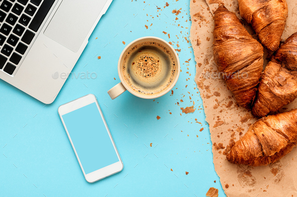 Coffee and croissants for messy breakfast in business office - Stock Photo - Images