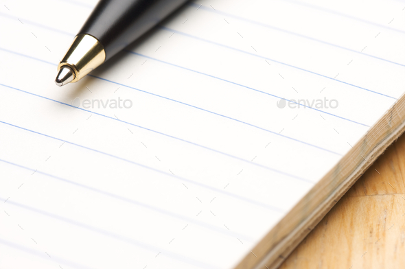 Pen and Pad of Lined Paper on a Wood Background - Stock Photo - Images