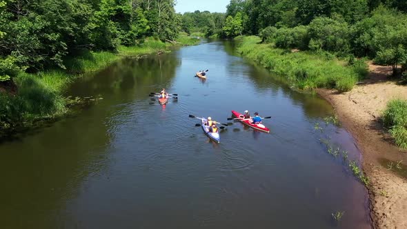 A Group of People Kayaking on the River