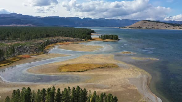 Aerial view flying over the marsh at Hebgen Lake along the shoreline alt