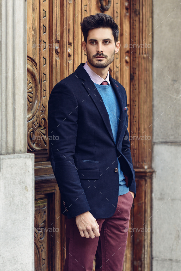 Attractive man wearing british elegant suit in the street. Modern hairstyle  Stock Photo by javi_indy