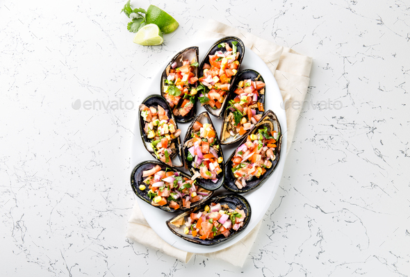 Choros a la chalaca. Big mussels, choros zapatos seasoned with purple onion - Stock Photo - Images