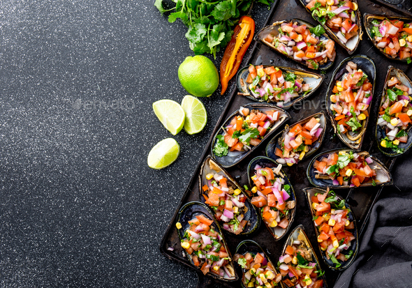Choros a la chalaca. Big mussels seasoned with purple onion, tomatoes, corn and lemon - Stock Photo - Images