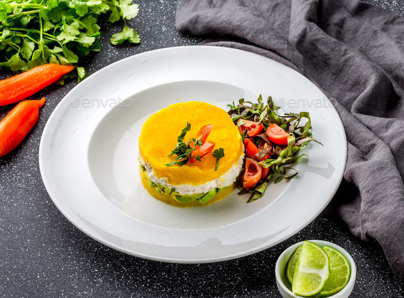 Traditional peruvian dish CAUSA from yellow potato, chicken, avocado on white plate. - Stock Photo - Images