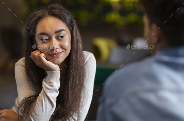 Flirty girl listening to her new boyfriend wth big interest Stock Photo by  Prostock-studio