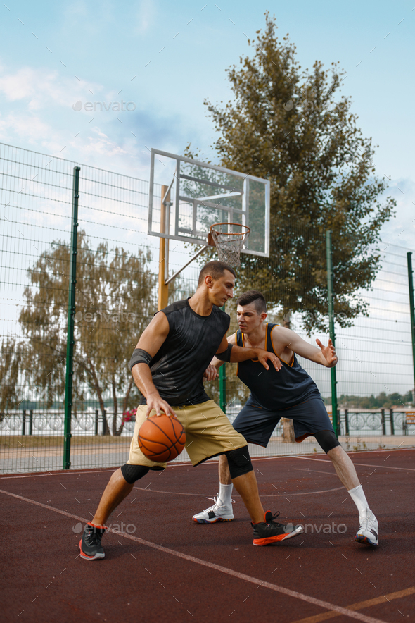 Basketball players set up a match on outdoor court