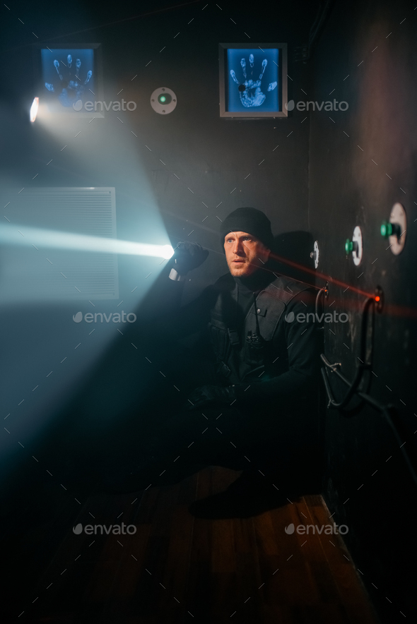 Robber with lantern trying to bypass the alarm