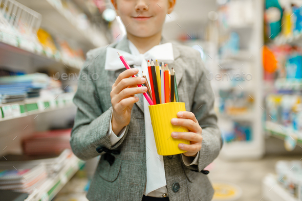 Schoolgirl with colorful pencils, stationery store