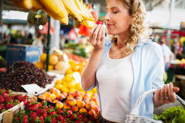 Young woman shopping healthy food on the market - Stock Photo - Images