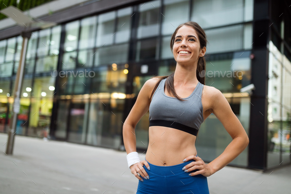 Young happy woman runner jogging in city outdoor - Stock Photo - Images