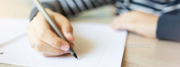 Kid Writing in Notebook. - Stock Photo - Images
