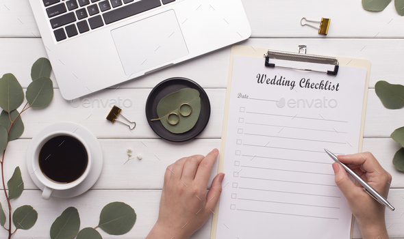Woman worker writing wedding checklist for bride