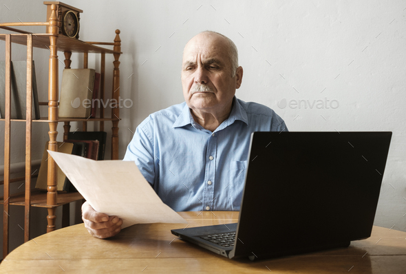 Senior man checking a handheld document