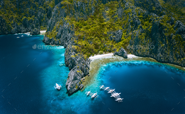 El Nido, Palawan, Philippines. Aerial view of Miniloc Island with diving boats above coral reef - Stock Photo - Images