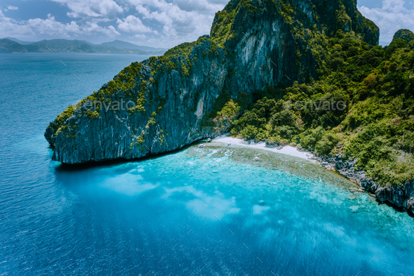 Aerial drone view of tropical Entalula Island. Huge steep rocks cliffs mountains surrounding blue - Stock Photo - Images