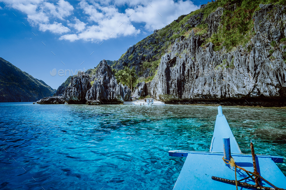 Banca boat approaching small beach at the Shrine, on Matinloc island, highlights of hopping trip - Stock Photo - Images