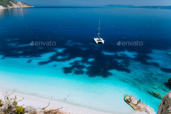 White catamaran yacht drift on clear azure water surface in calm blue lagoon with transparent water - Stock Photo - Images