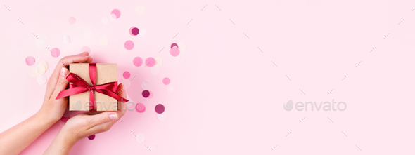 Woman`s Hands Holding Gift Box on Pink Background. - Stock Photo - Images